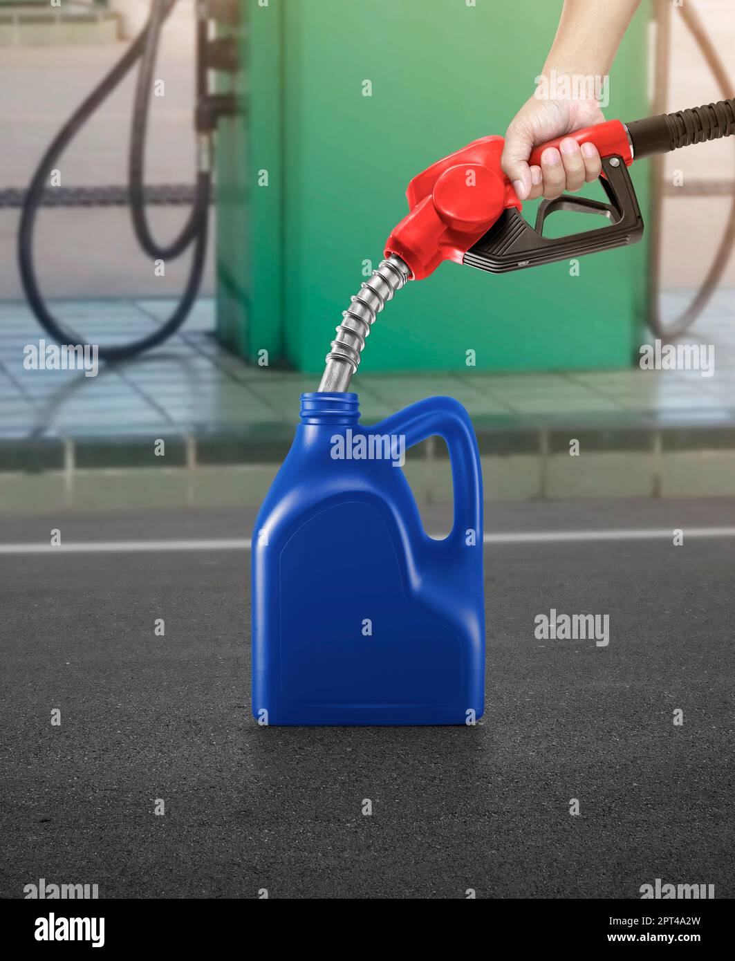 A man fills jerry cans at a gas station Stock Photo Alamy
