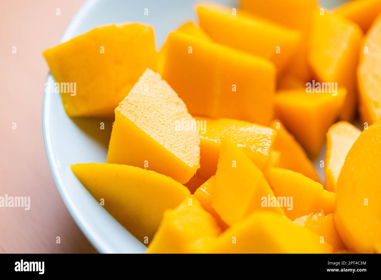Diced fresh mango fruit on plate Stock Photo