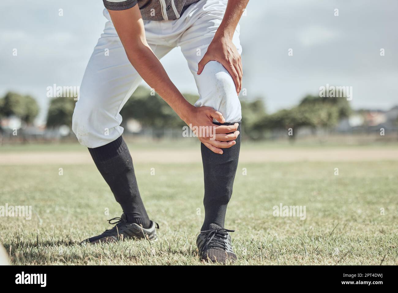 Baseball leg injury, man and sports athlete on a outdoor grass field ...