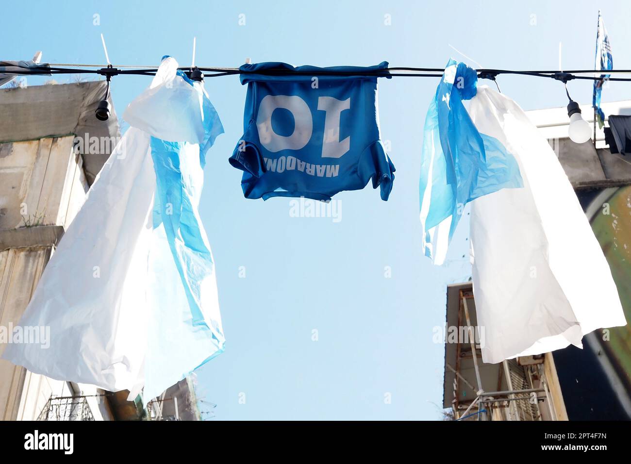 Napoli, Italy. 27th Apr, 2023. Diego Armando Maradona shirts displayed in the alleys of Forcella, during the preparations for the celebration of the victory of the Italian Serie A championship and the third scudetto 'shield with the colors of the Italian flag, which is worn on the game uniform by the team that won the championship in the previous season'. Credit: Vincenzo Izzo/Alamy Live News Stock Photo