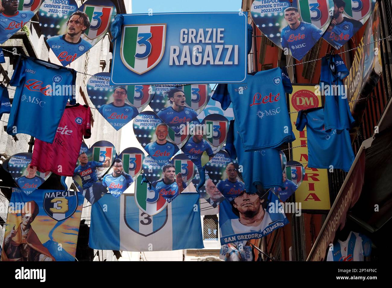 Napoli, Italy. 27th Apr, 2023. Flags and banners in honor of Napoli displayed in the alleys of Forcella, during the preparations for the celebration of the victory of the Italian Serie A championship and the third scudetto 'shield with the colors of the Italian flag, which is worn on the game uniform by the team that won the championship in the previous season'. Credit: Vincenzo Izzo/Alamy Live News Stock Photo
