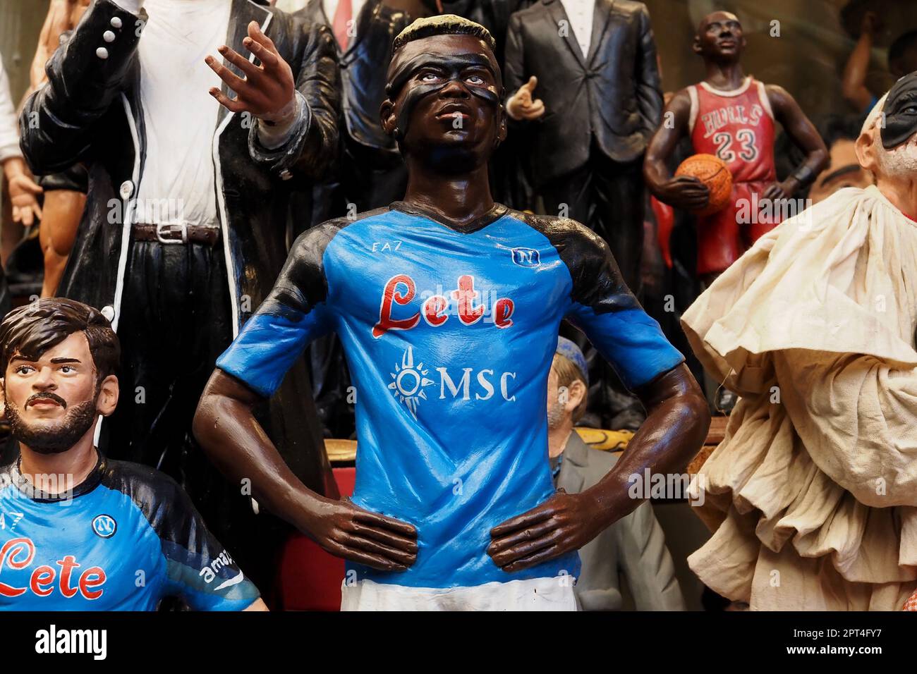 Napoli, Italy. 27th Apr, 2023. Statuette depicting the Napoli player Victor Osimhen, during the preparations for the celebration of the victory of the Italian Serie A championship and the third scudetto 'shield with the colors of the Italian flag, which is worn on the game uniform by the team that won the championship in the previous season'. Credit: Vincenzo Izzo/Alamy Live News Stock Photo