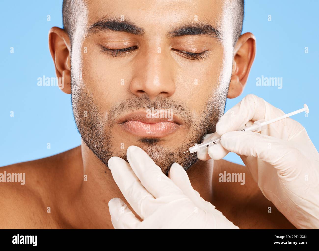Beauty, facial and botox with face of man for plastic surgery, aesthetic and skincare. Medical, prp injection and spa with model against blue backgrou Stock Photo