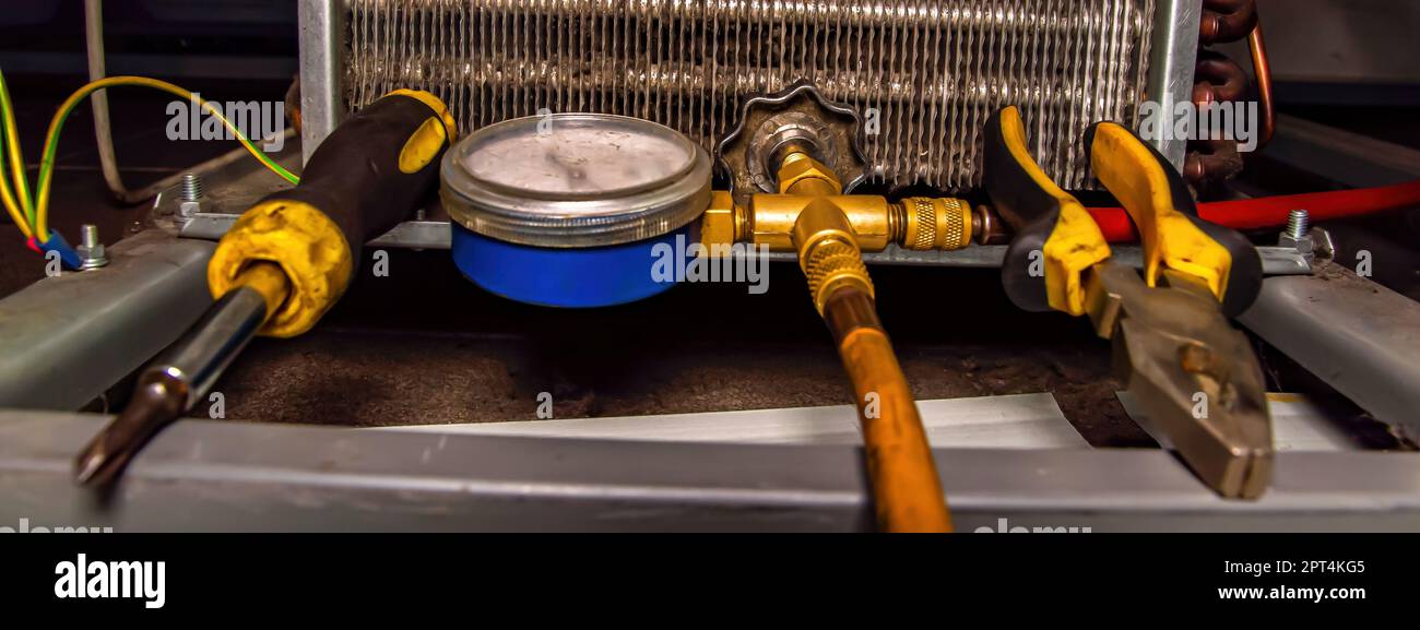 Filling an industrial refrigeration unit with freon. Refrigerator