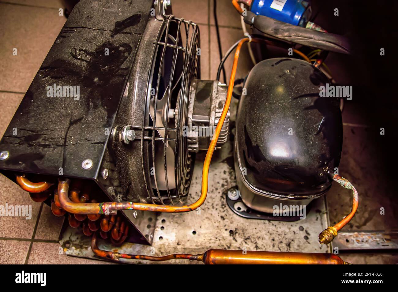 Repair of the engine of an industrial refrigerator unit. Refrigerator