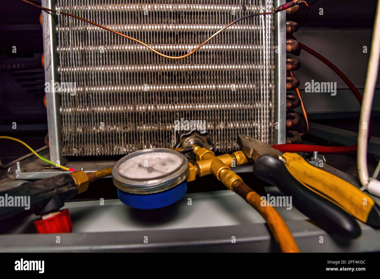 Filling an industrial refrigeration unit with freon. Refrigerator