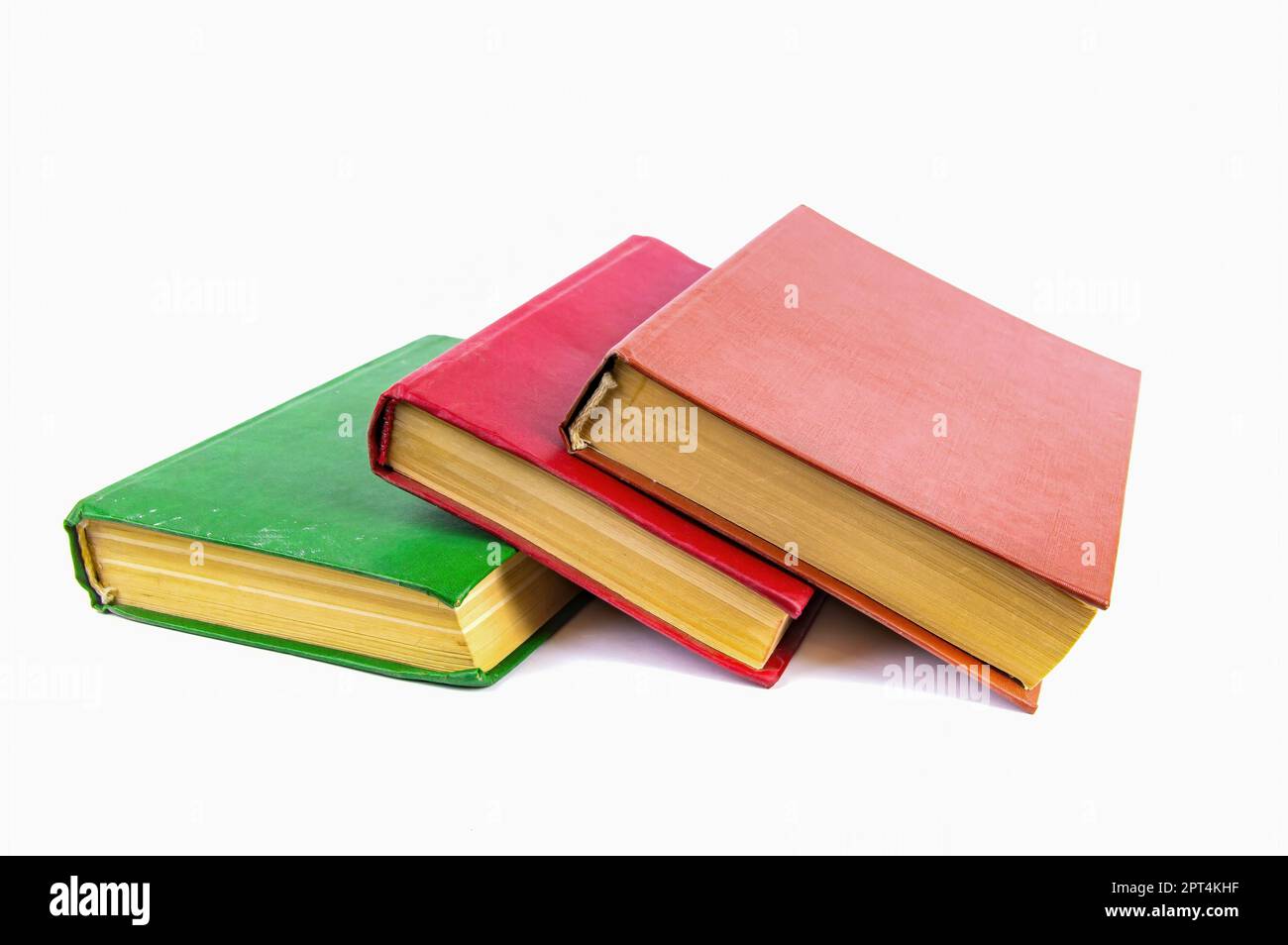 A stack of old books with colored covers. Books for reading. Old book. Book page of yellow paper. White background. Paper product. Read literature. Ba Stock Photo