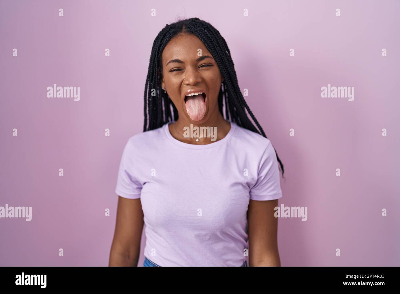 African american woman with braids standing over pink background ...