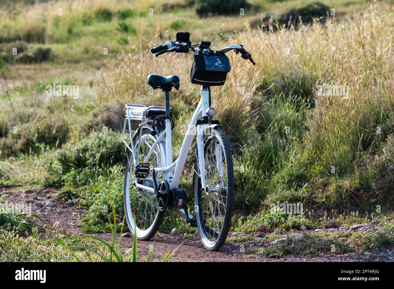 Peyia, Cyprus, March 27, 2023 - Electric bicycle standing on a rough outdoor location Stock Photo