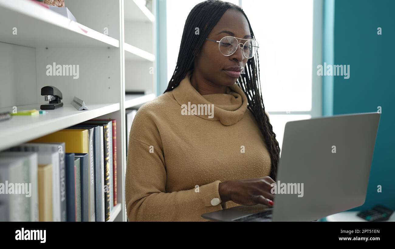 Focused african woman braids using hi-res stock photography and images ...