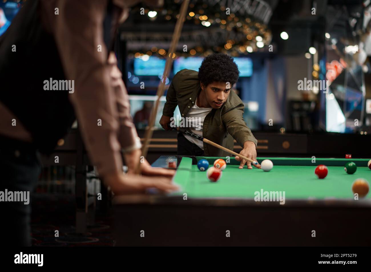 Billiards game. young friends playing pool together Stock Photo - Alamy