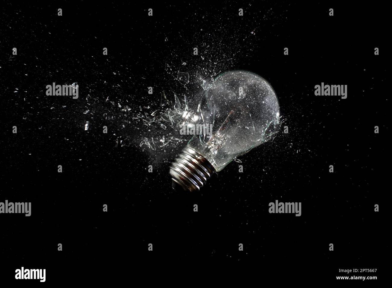 light bulb shattering on black Stock Photo