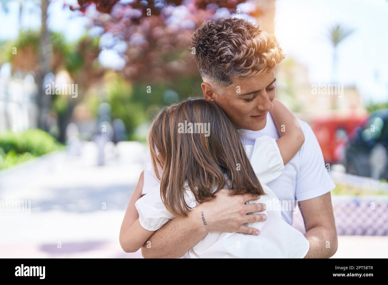 Father and daughter smiling confident hugging each other at park Stock ...