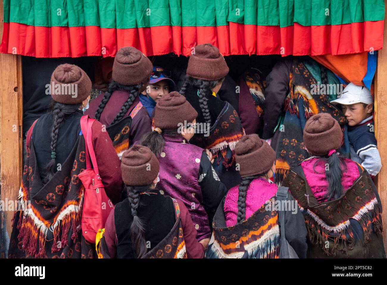 Traditionally dressed women enter the prayer hall during Stongdey