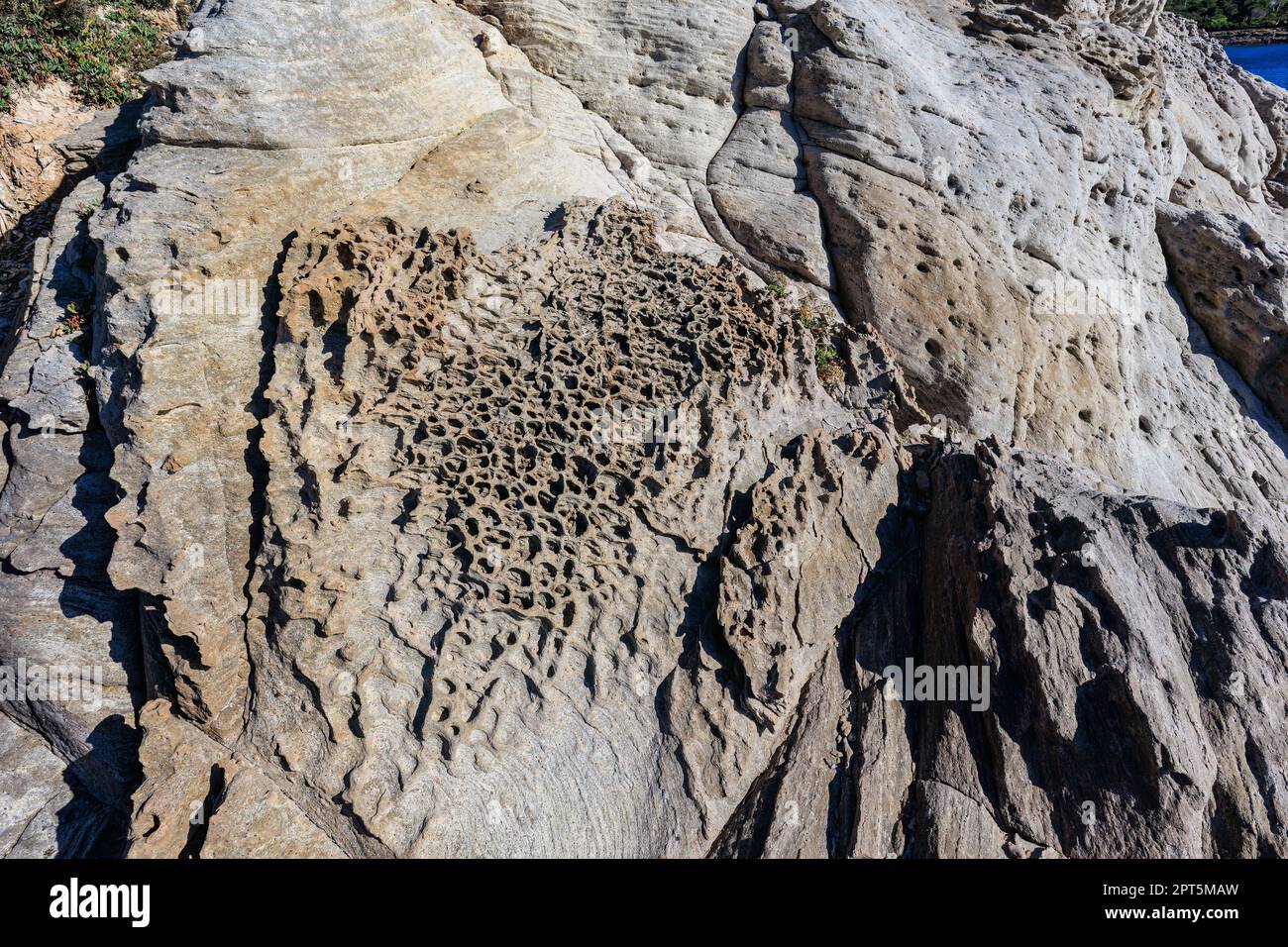 unusual rock formations of the volcanic cliff on Cala Sapone beach ...