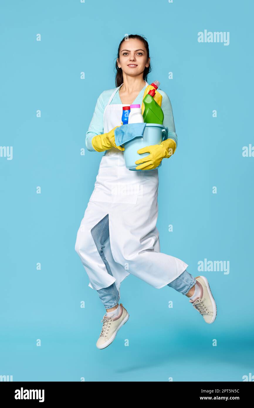 happy cheerful woman in rubber gloves and cleaner apron with cleaning ...
