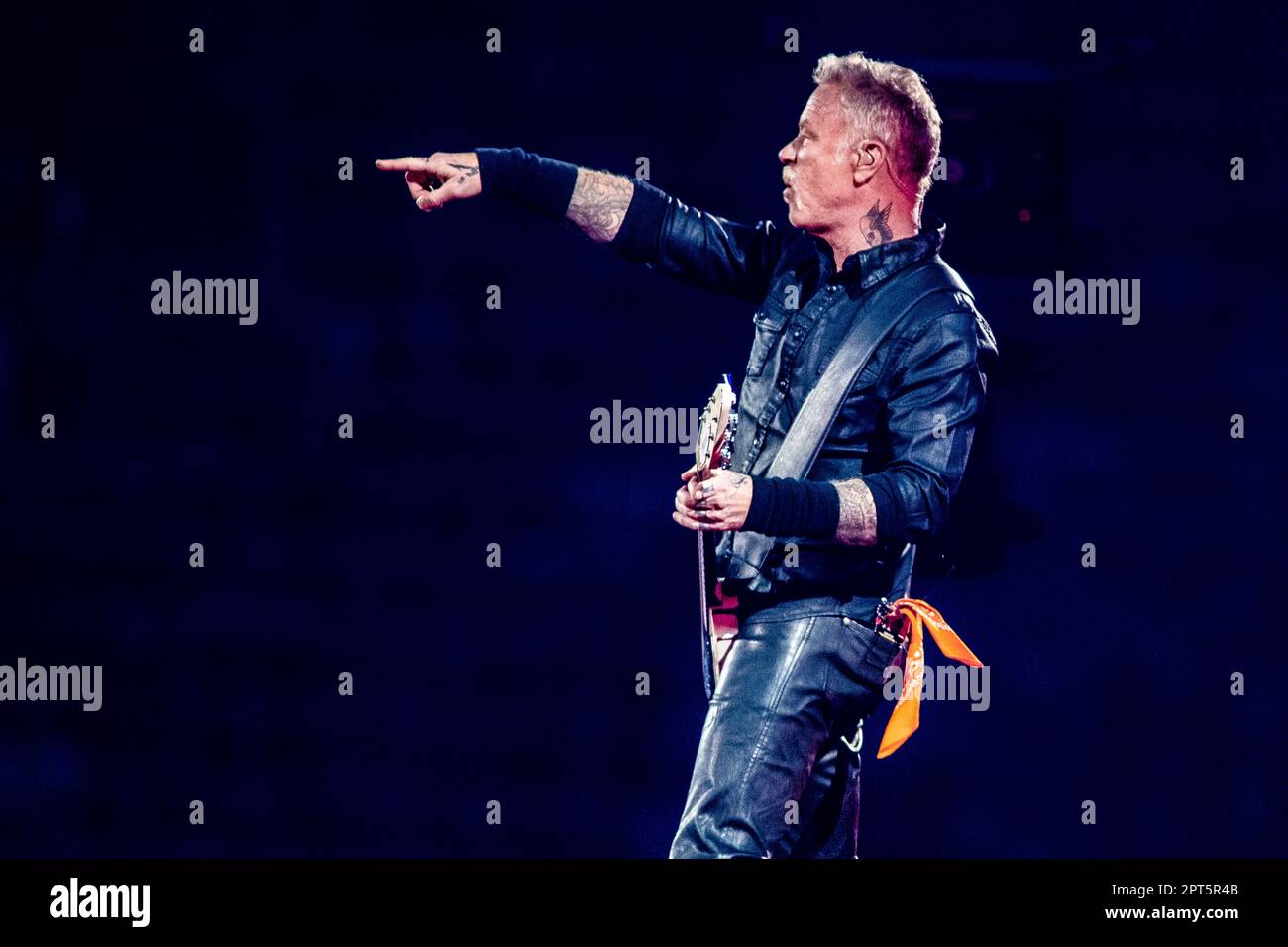 AMSTERDAM - 27/04/2023, Singer and guitarist James Hetfield of rock band Metallica with an orange scarf from his pocket during a performance (M72 World tour) in Johan Cruijff ArenA. ANP PAUL BERGEN netherlands out - belgium out Stock Photo