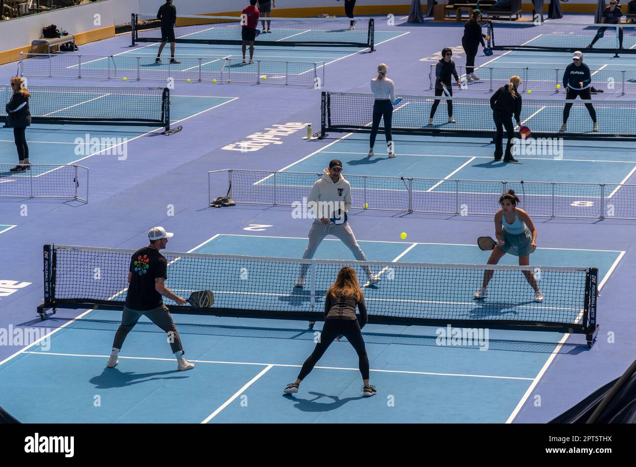 Pickleball players in the Wollman Ice Skating rink, converted into 14 pickleball courts, on