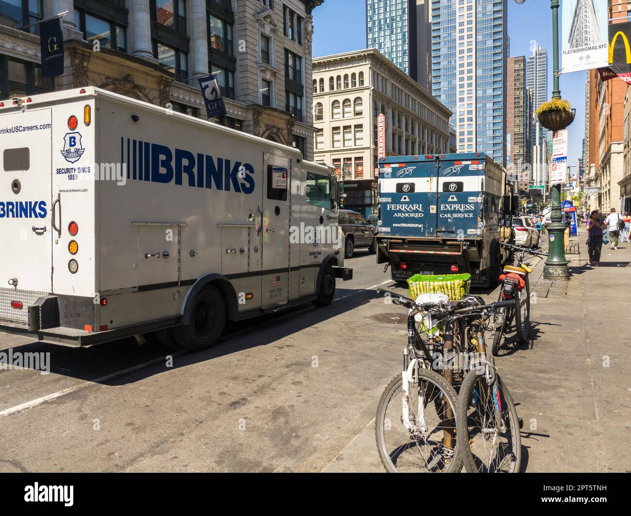Armored trucks from The Brink's Company and Ferrari Express Armored Car Service in the Chelsea neighborhood in New York on Thursday, April 13, 2023.  (© Richard B. Levine) Stock Photo