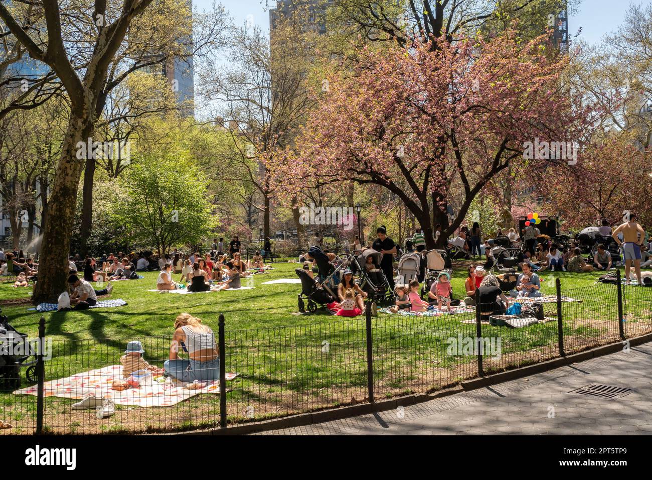 People take advantage of the unseasonably warm weather in Madison Square Park in New York on Thursday, April 13, 2023. Spring temperatures are expected to reach almost 90 degrees making April feel more like July. (© Richard B. Levine) Stock Photo