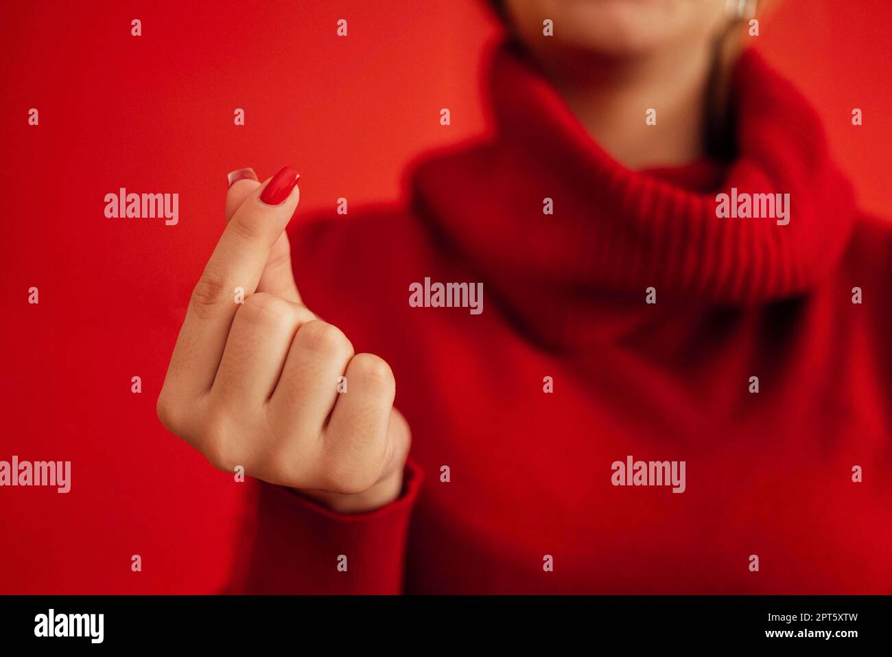 The Korean symbol for love is obvious. A woman's hand covers a heart. Place for text. Happy Valentine's day Stock Photo