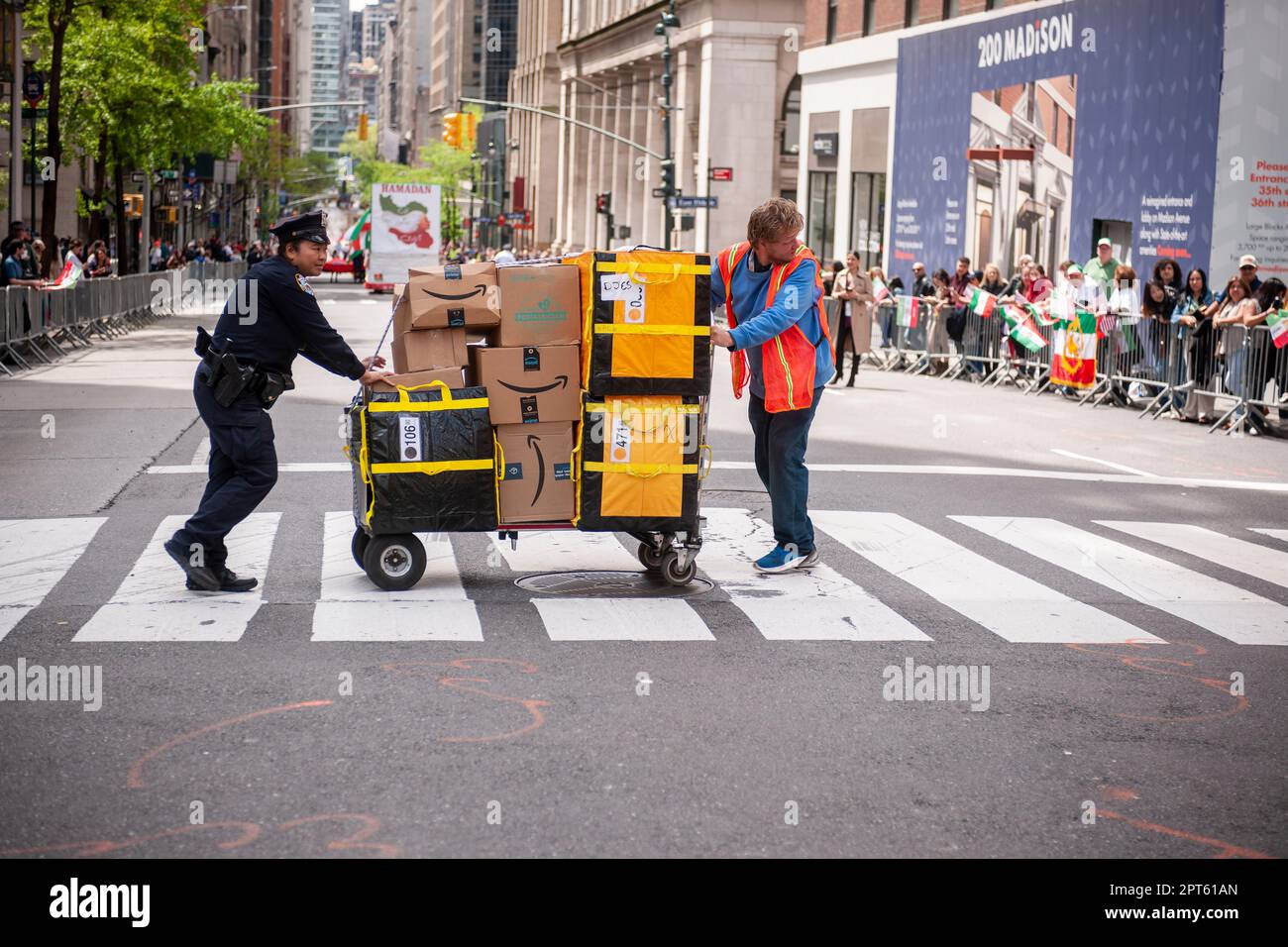 NYPD officer assists Amazon worker crossing Madison Avenue in New York