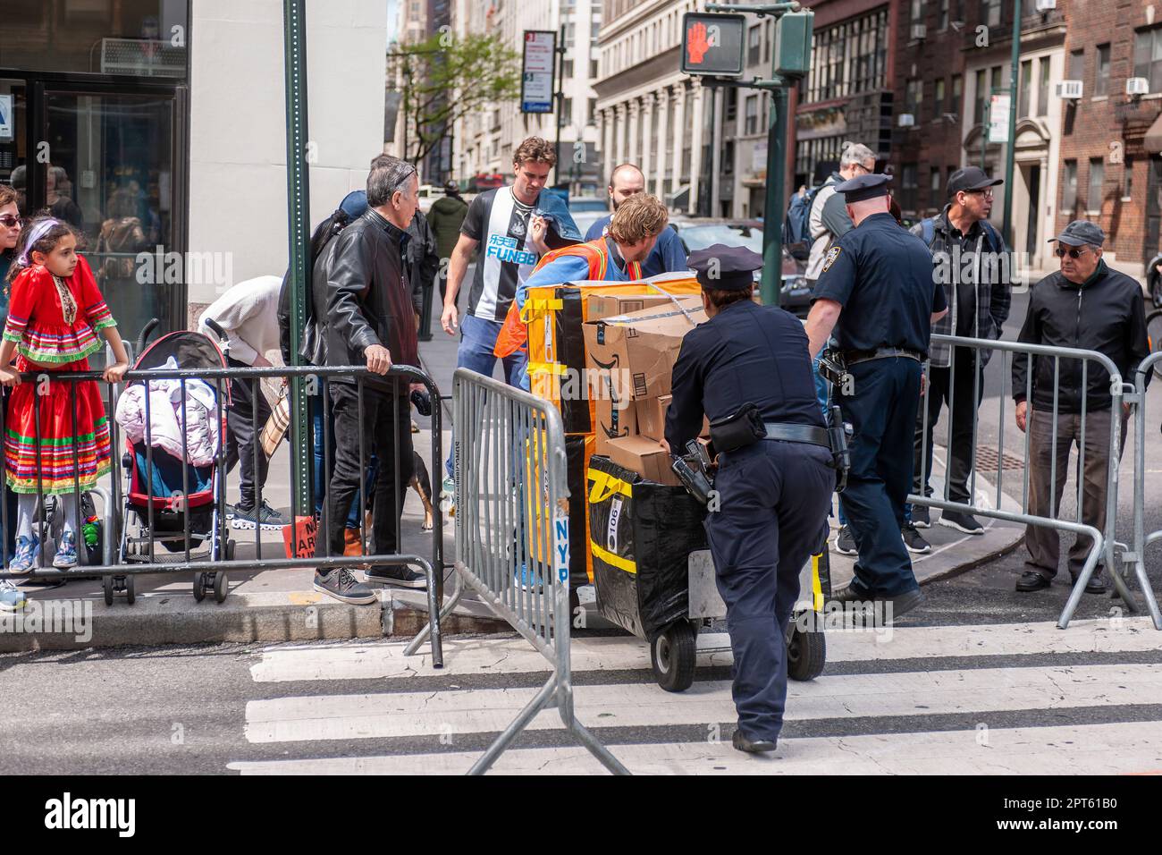 NYPD officer assists Amazon worker crossing Madison Avenue in New York