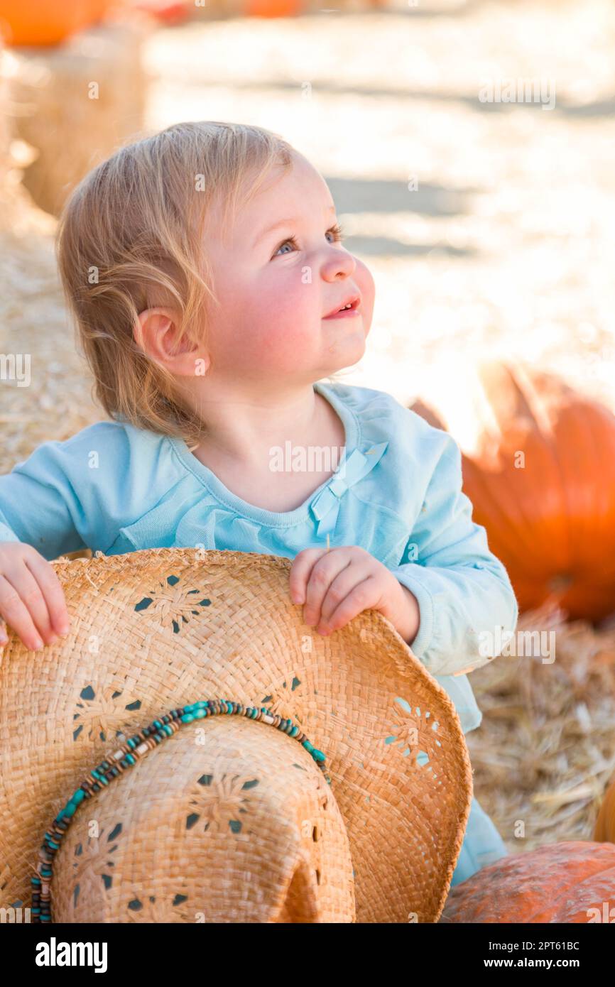 Adorable Baby Girl with Cowboy Hat in a Country Rustic Setting at the Pumpkin Patch Stock Photo Alamy