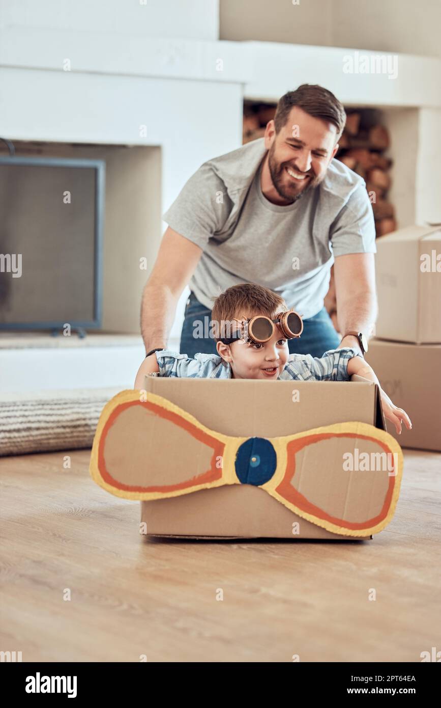 Happy single father pushing his little kid in homemade aeroplane