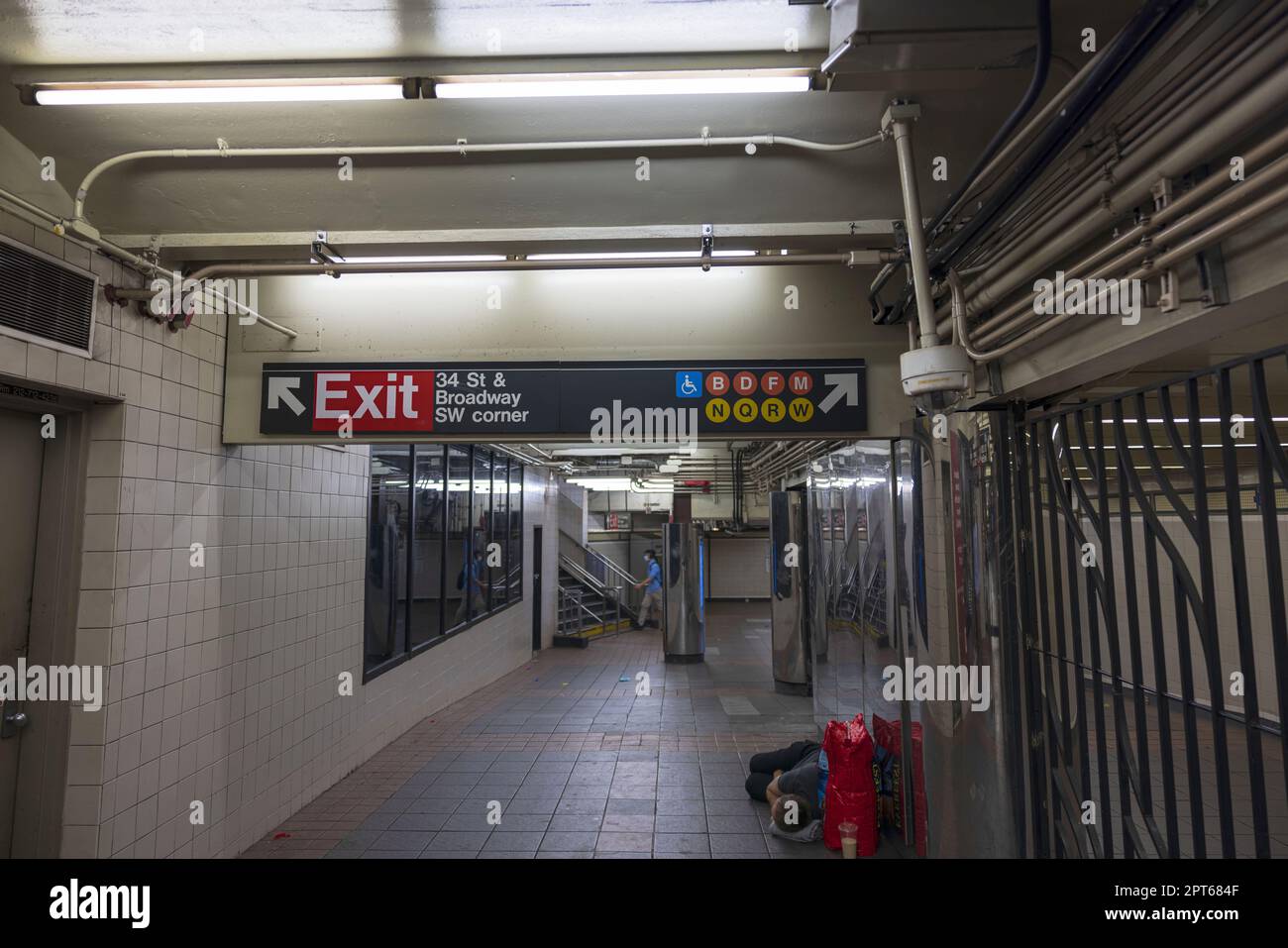 Interior view of subway station where homeless man sleeps on floor. New York, USA. Stock Photo