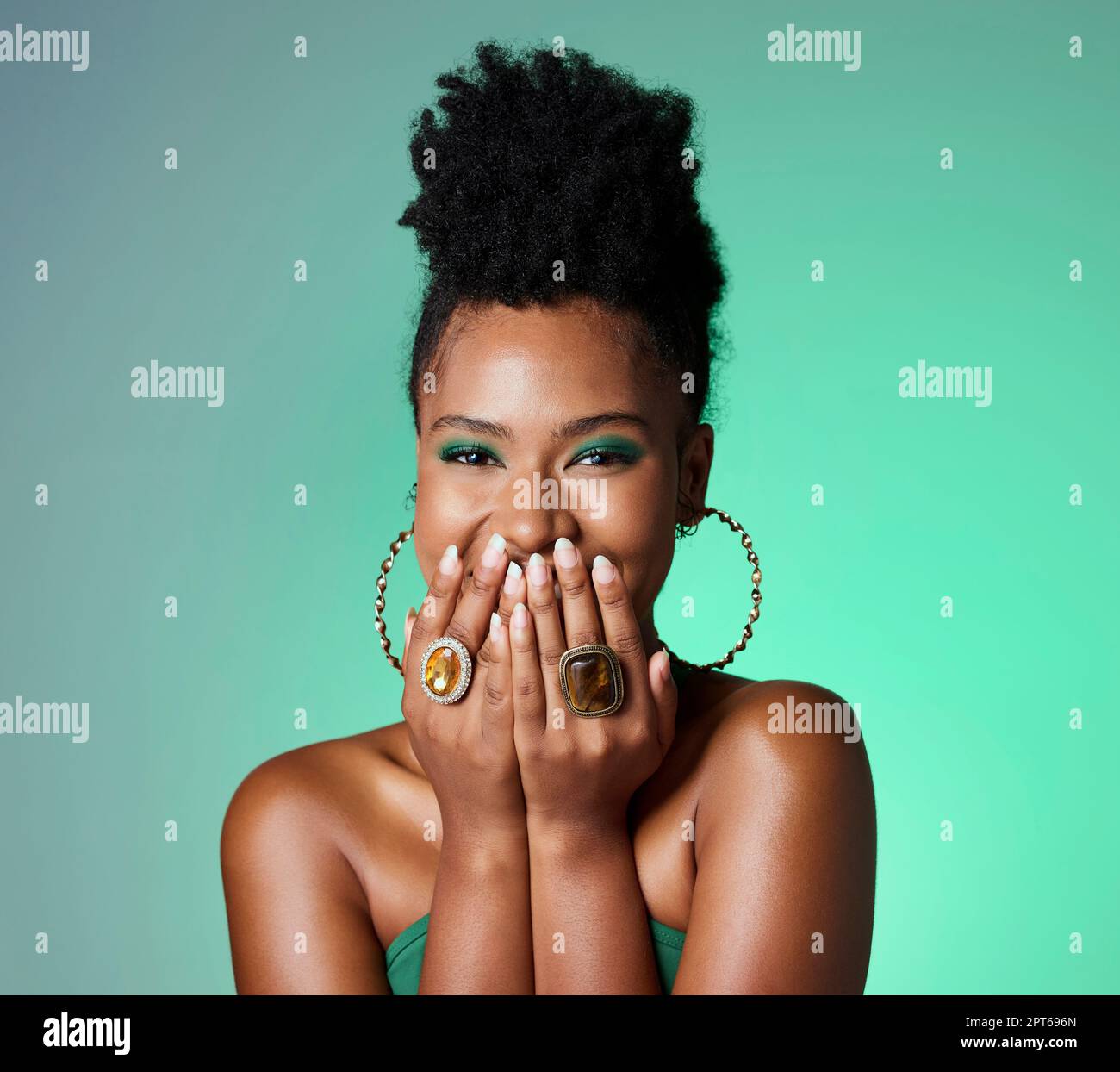 Beauty, green fashion and makeup with a black woman laughing in studio on a wall background