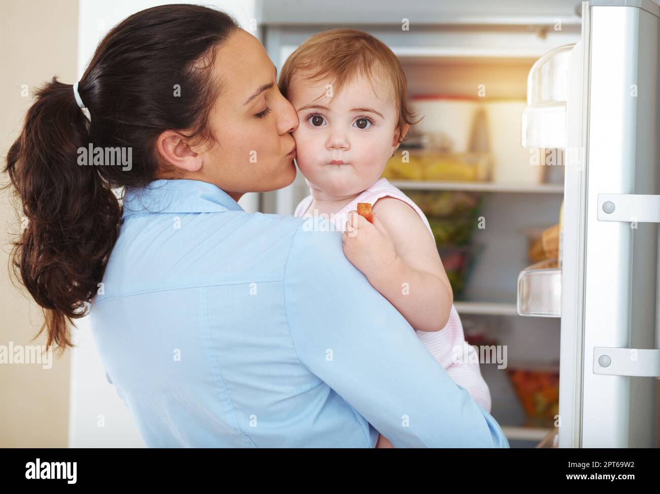 Kisses from Mom are the best. an affectionate young mother at home with her baby Stock Photo Alamy