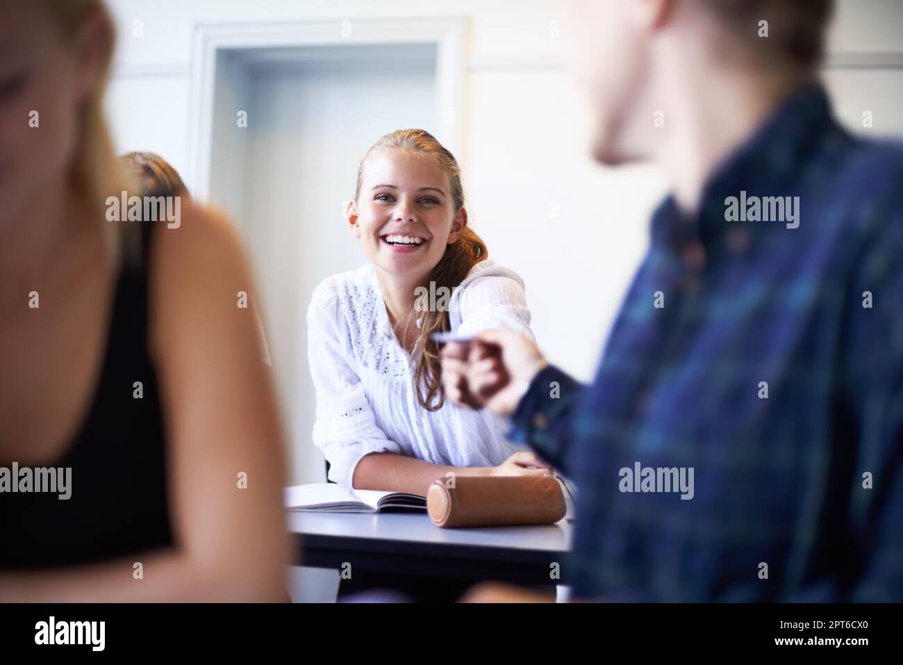 Give this to Adele. A teenage boy getting a letter from a girl sitting