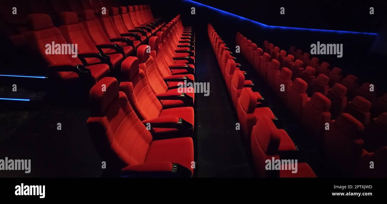 Empty cinema hall with red seats. Interior of modern movie theatre