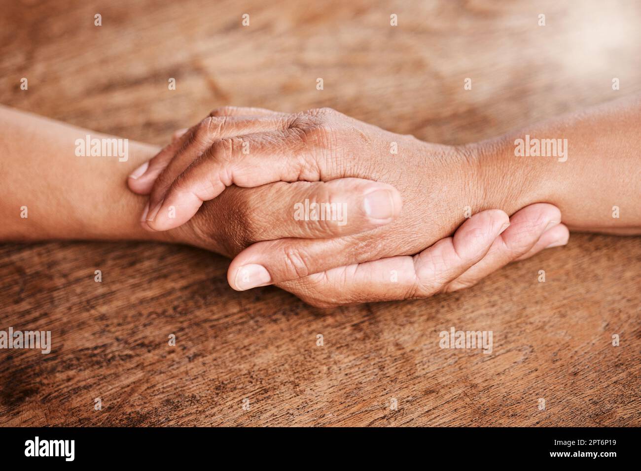 Stitched up by the hands of fate. an unrecognizable senior couple holding hands and comforting one another at home Stock Photo