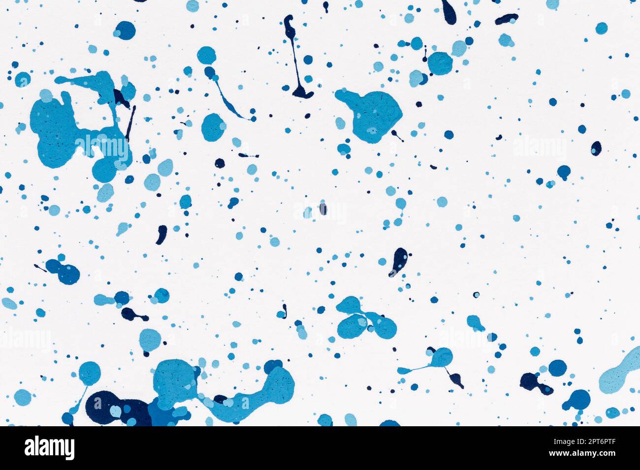 Blue drops paint texture background blue color on white paper. Brush