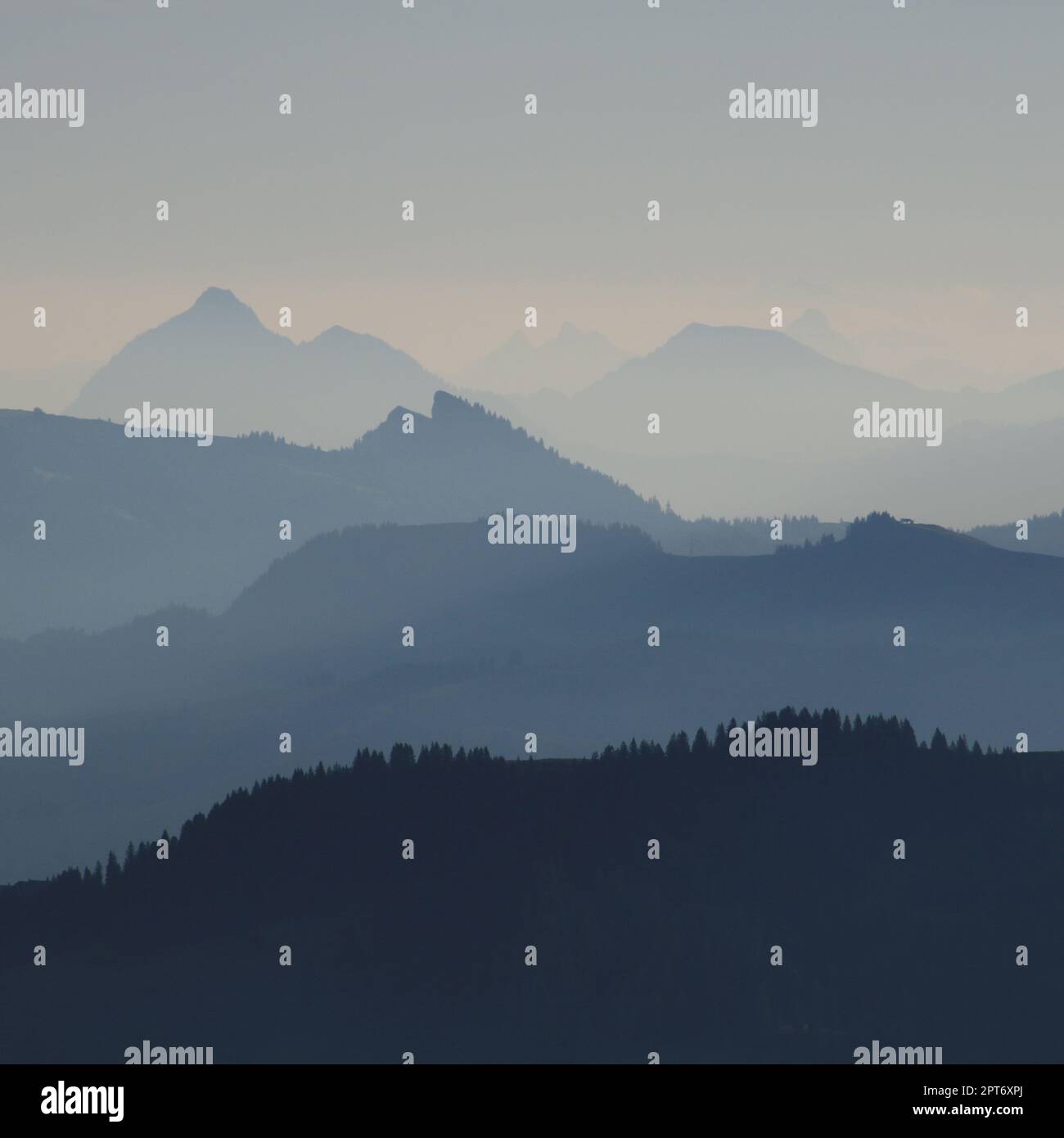 Layered mountain ranges in different shades of blue Stock Photo - Alamy