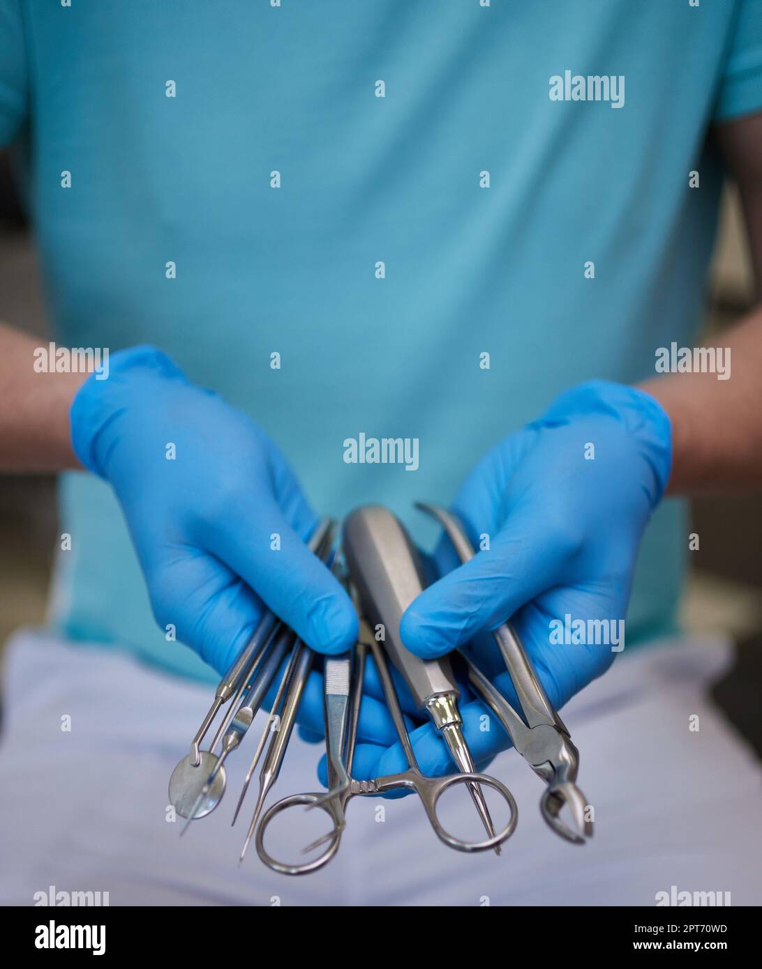 Close up of hands dentist in sterile latex gloves holding dental tools