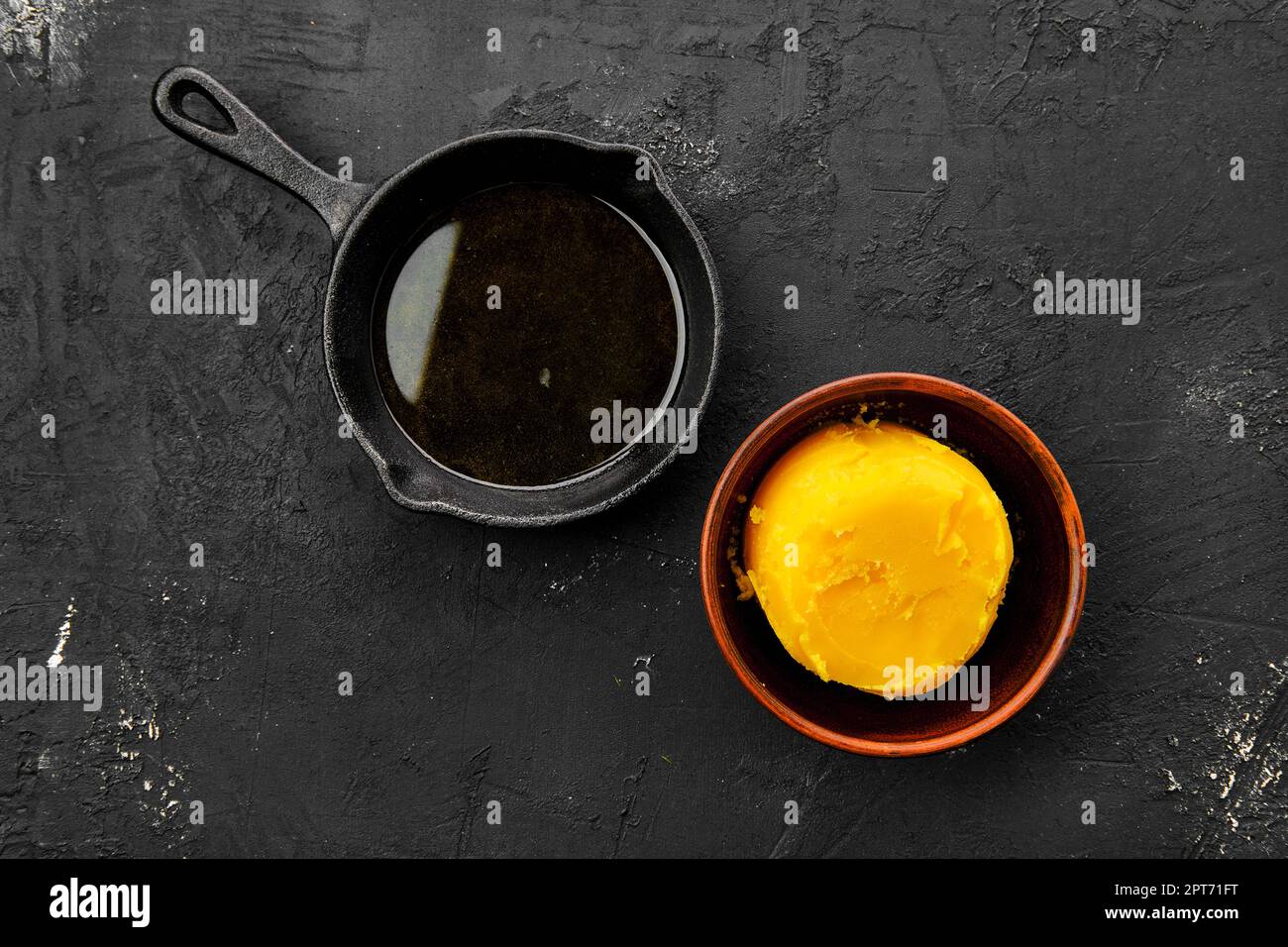 Homemade rustic melted butter and small cast iron skillet Stock Photo