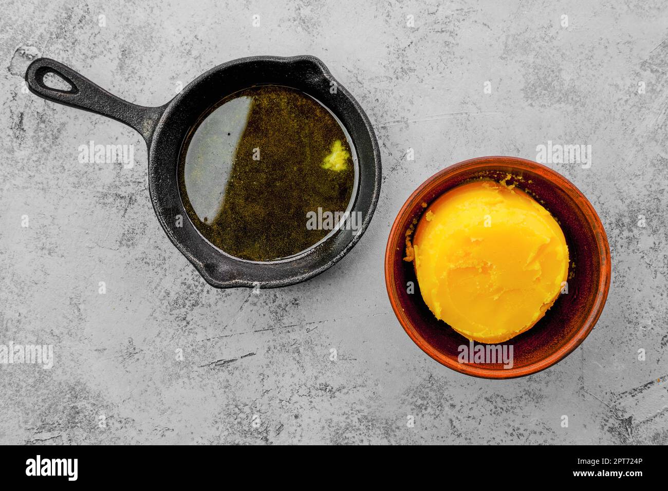 Homemade rustic melted butter and small cast iron skillet Stock Photo