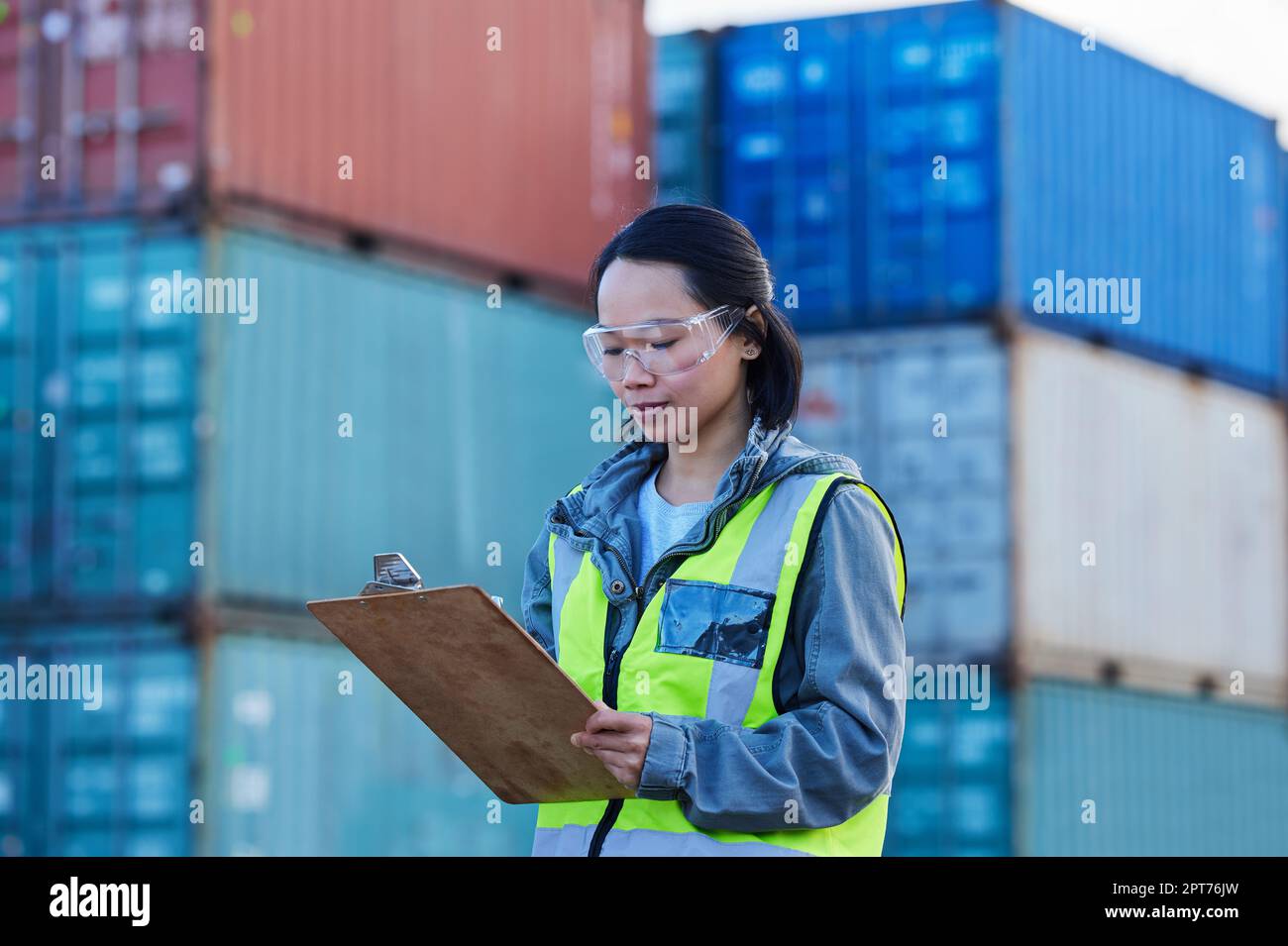 Logistics, Asian woman and check containers, export and import for supply  chain at shipyard with clipboard. Female supervisor, planning or confirm sto  Stock Photo - Alamy
