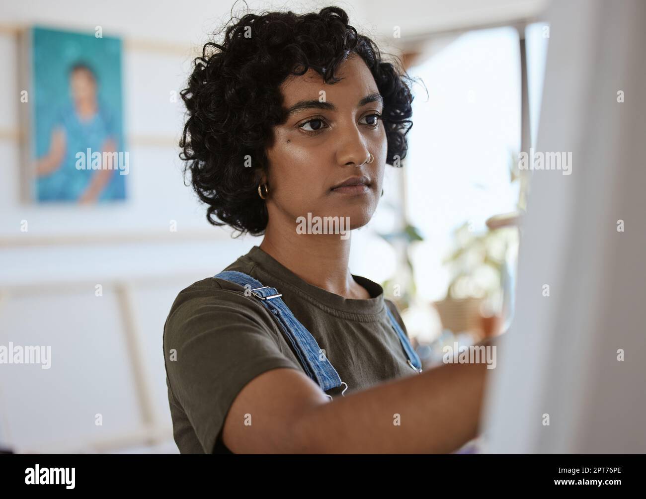 Art, creative and woman painting on canvas in a or studio for creativity. Face on an