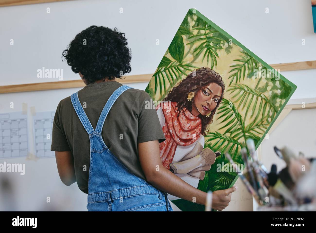 Painting, woman artist and hanging canvas wall for exhibition, expo