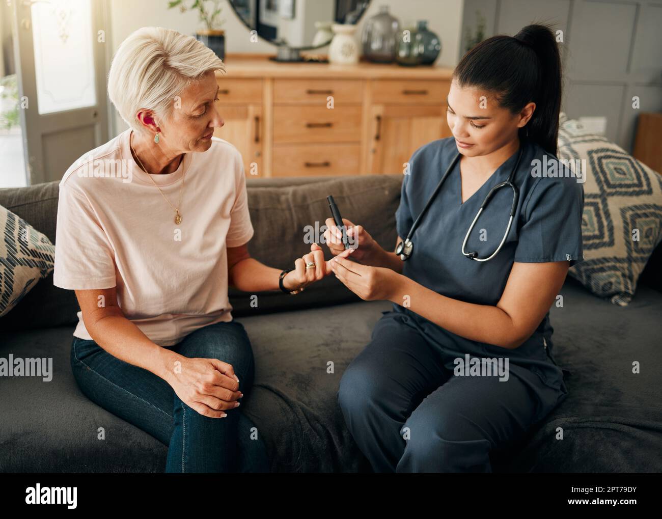 Diabetes, healthcare nurse and elderly woman finger doing blood test