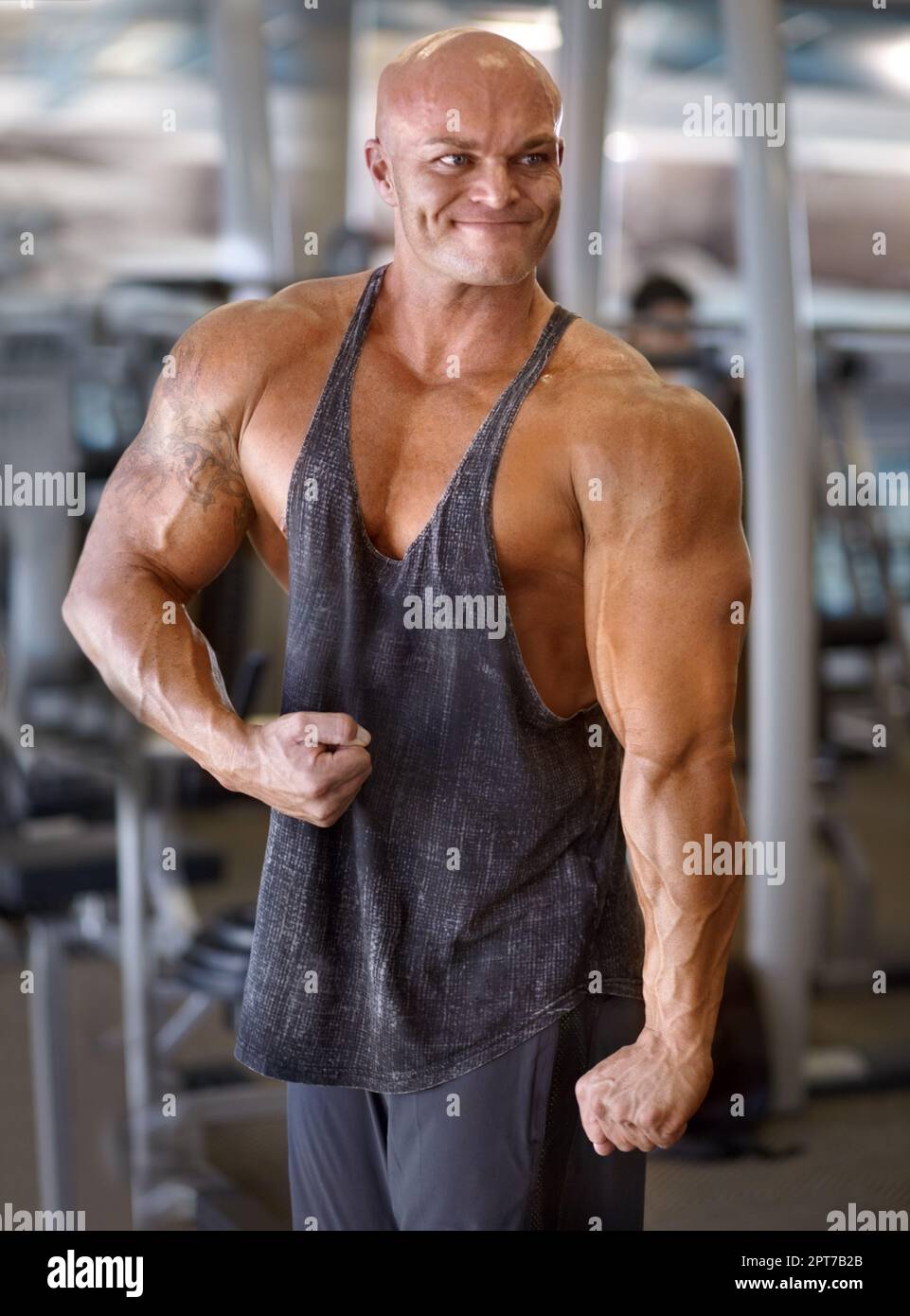 He Is At His All Time Best A Muscular Bodybuilder Flexing His Muscles While Standing In The Gym 6527