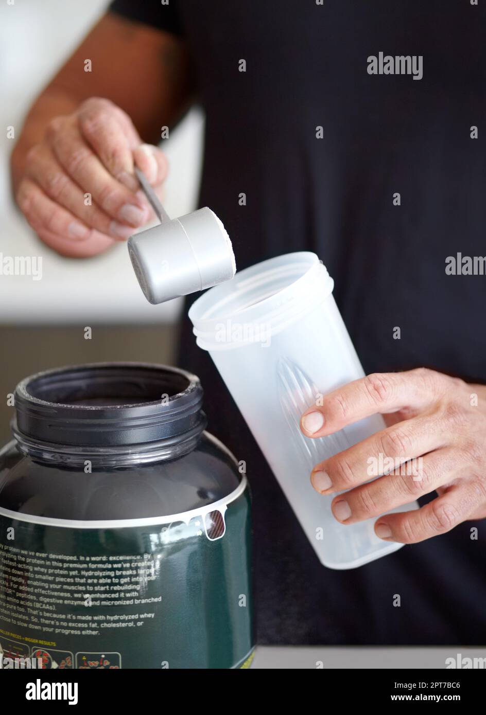 Mixing up a meal replacement. Cropped image of a bodybuilder making