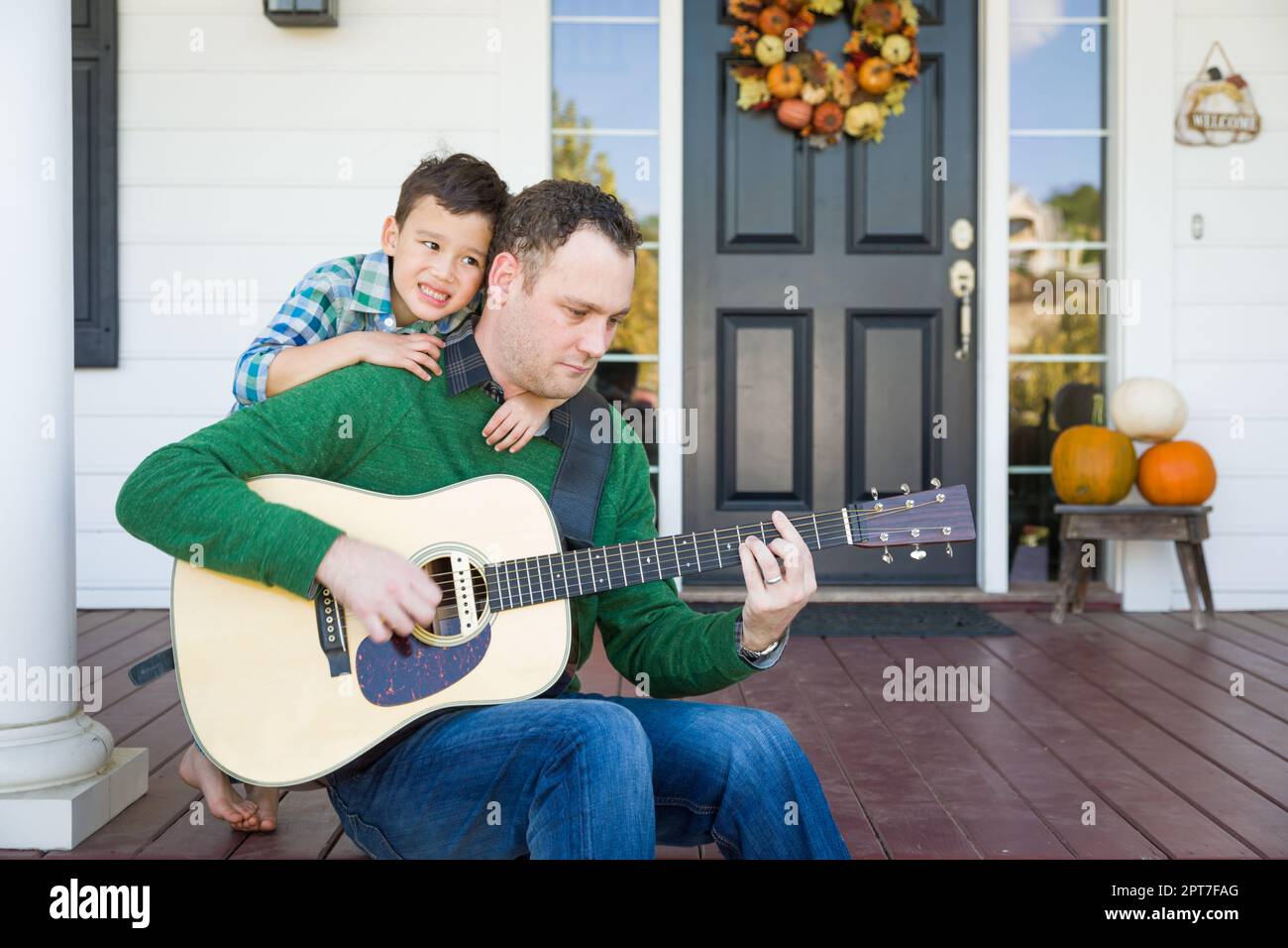 Young Mixed Race Chinese And Caucasian Son Singing Songs And Playing