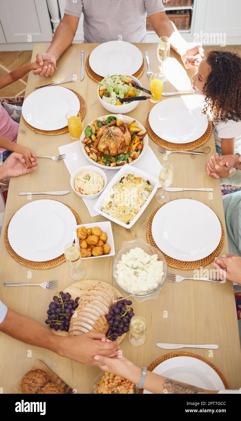 Pray, food and family friends dinner at a table with gratitude, love