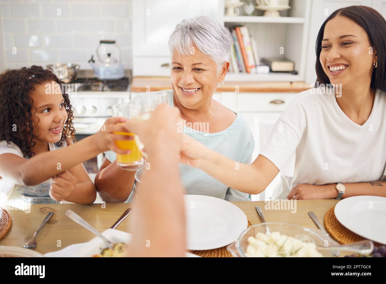 Orange juice, celebration and family breakfast with child and grandmother for wellness, healthy life and growth development. Senior woman, girl kid or Stock Photo