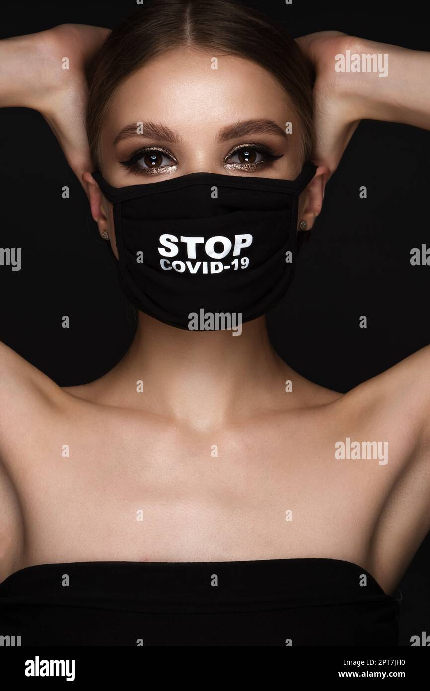 Portrait of a beautiful woman in a black mask stop covid and classic ...